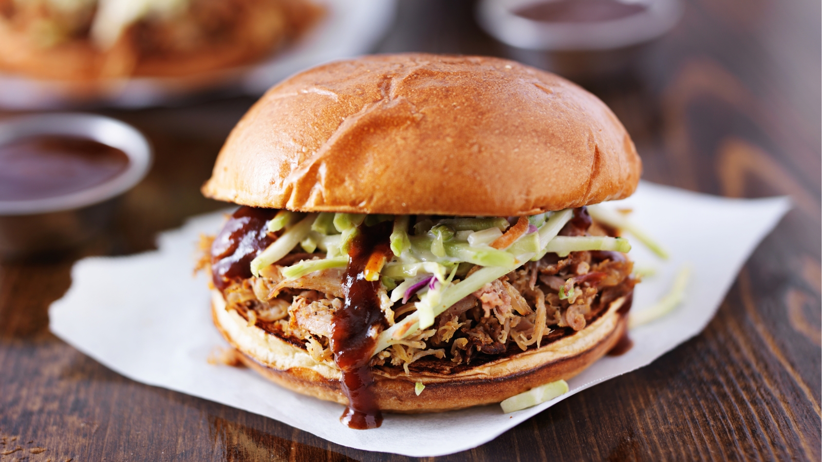 Barbecue pulled pork sandwich topped with coleslaw.