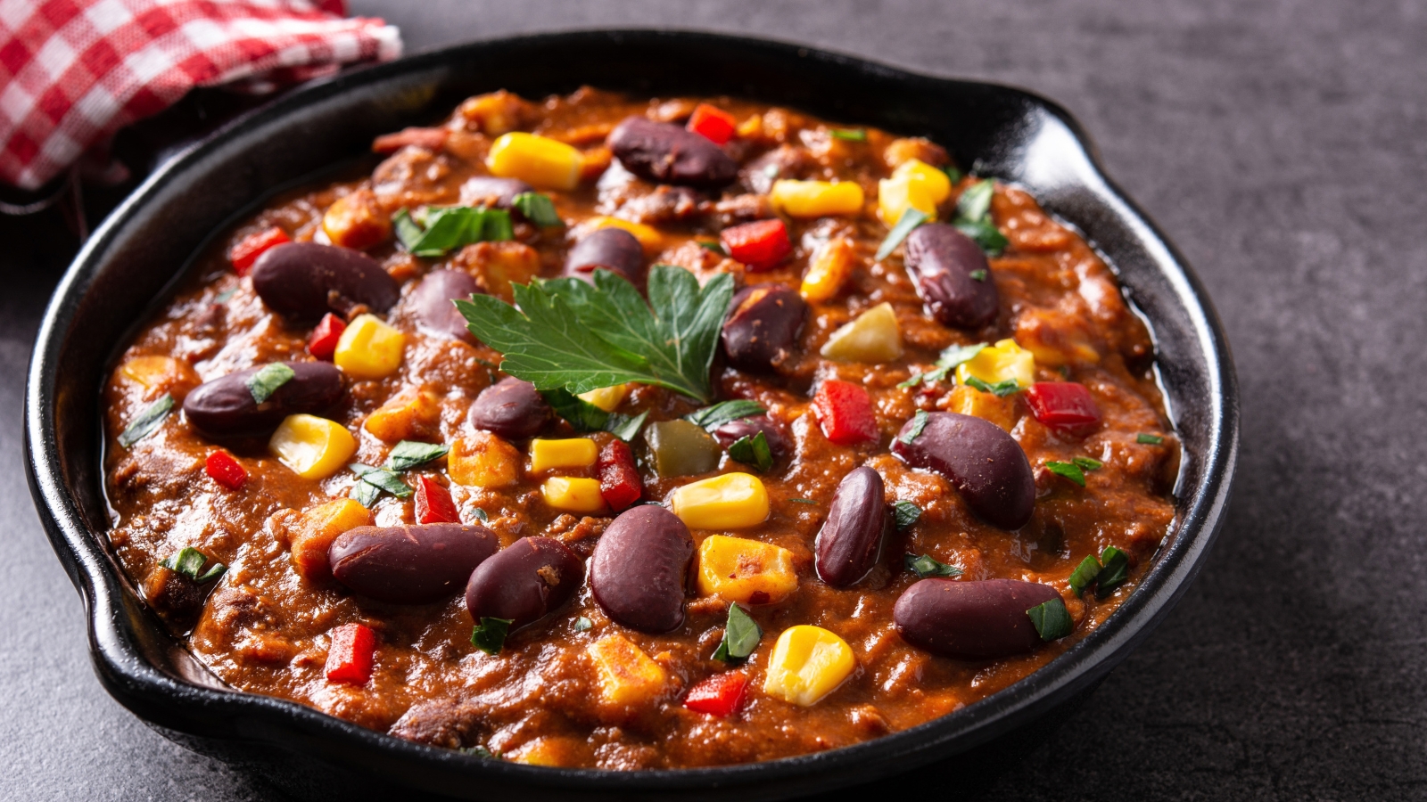 Thick chili with kidney beans, corn, peppers, and herbs.