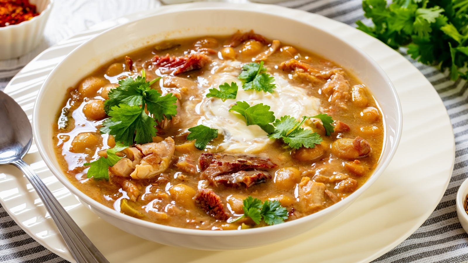 White bean and chicken chili topped with sour cream and cilantro.